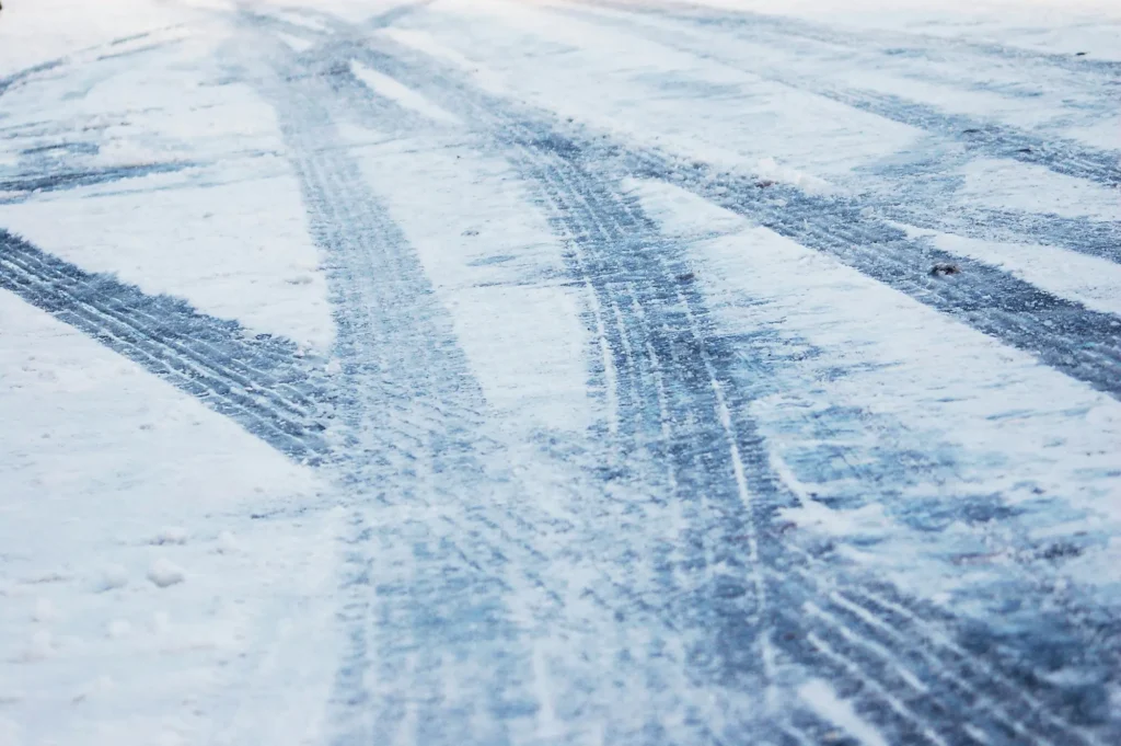 tire tracks on snowy, icy road